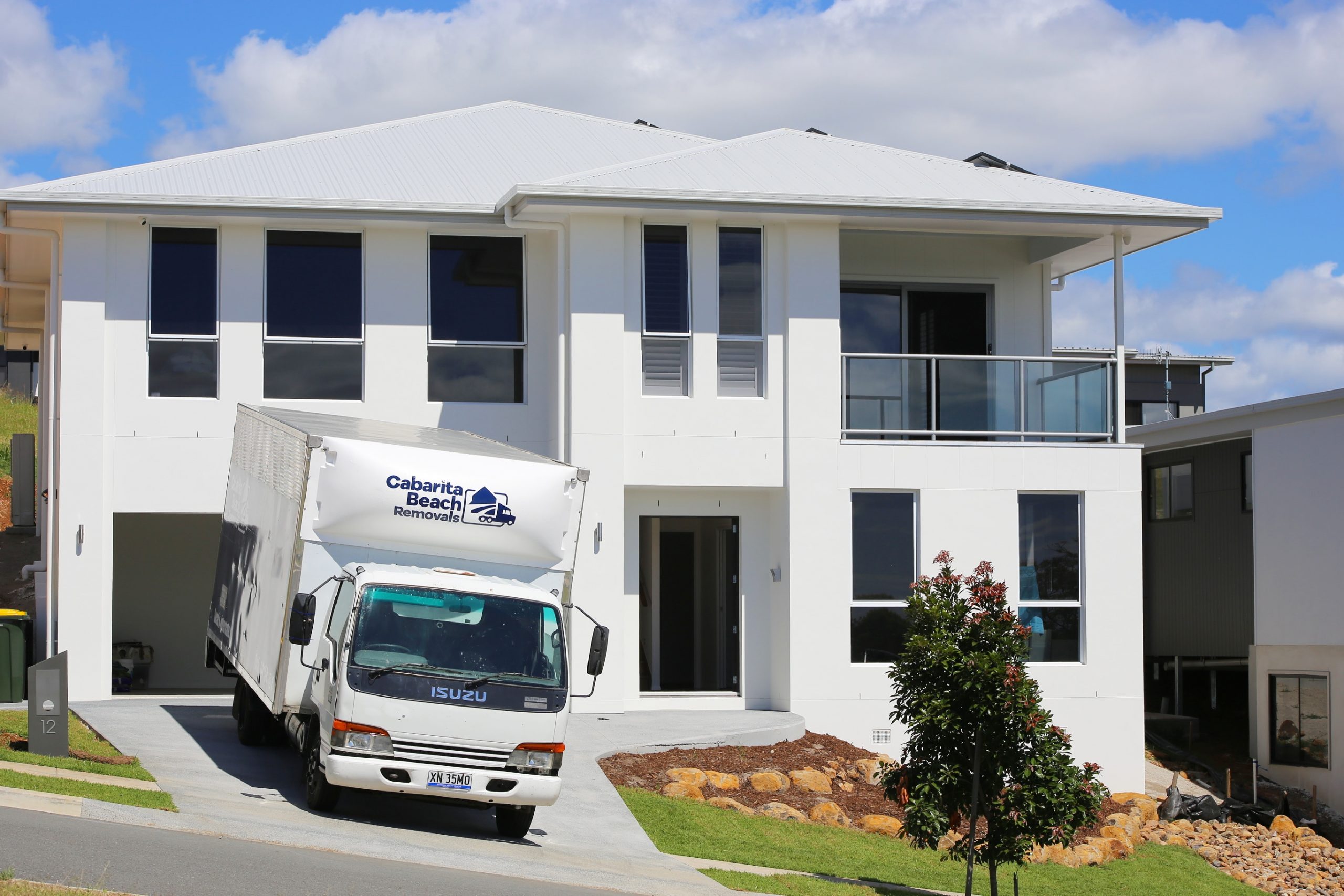 A White Color Truck in Front of a White Building