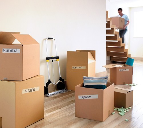 A Man Carrying a Box Up a Stairs