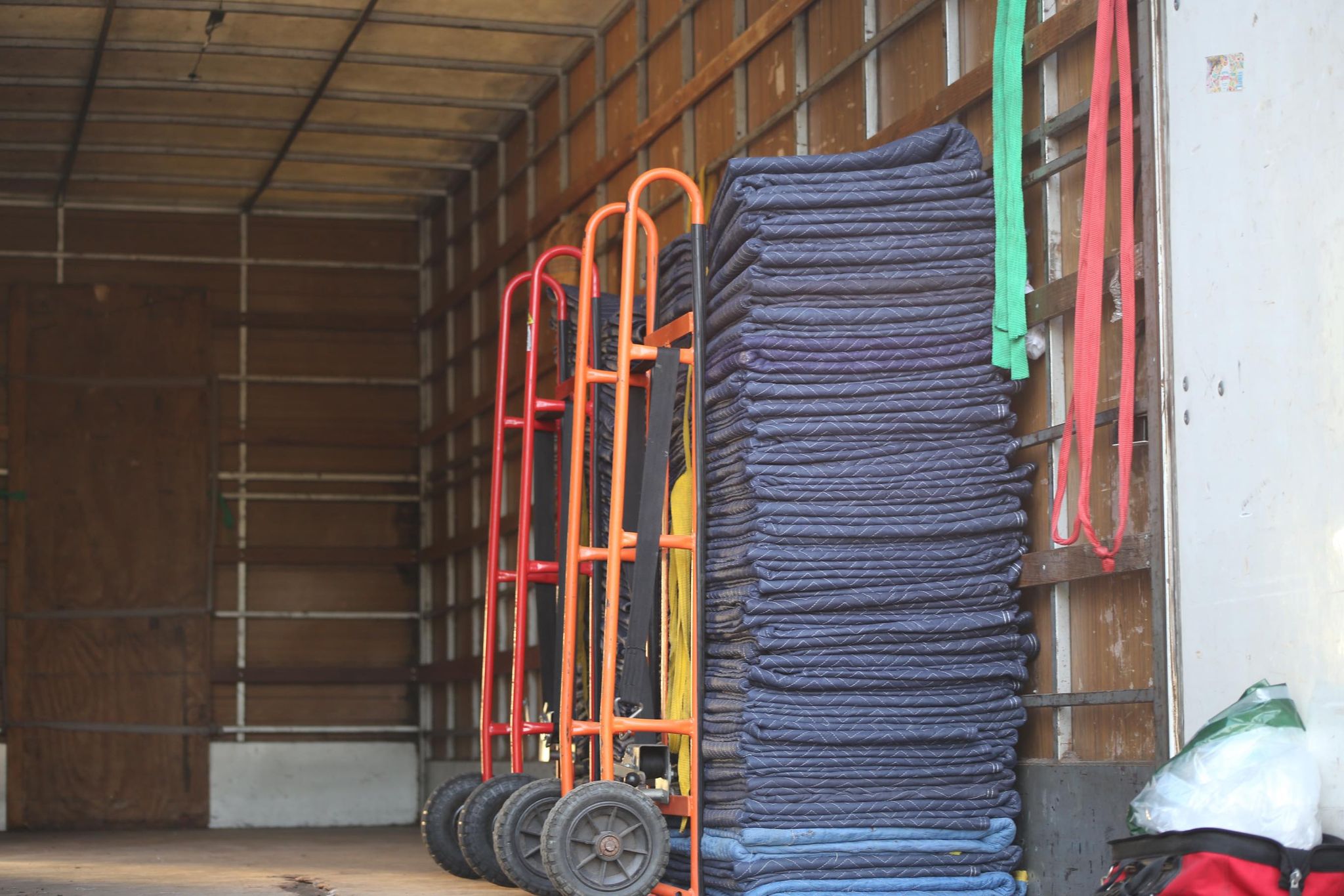 A Man Fork Lift Inside a Truck With Stack of Sheets