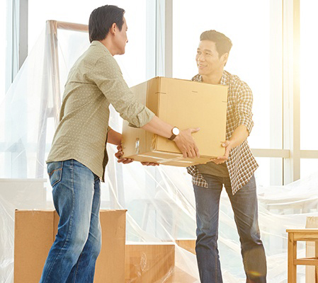 A Man Handing Over a Box to Another