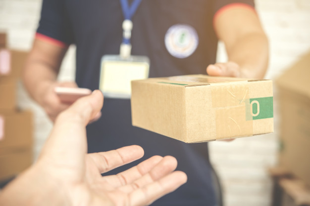 A Delivery Man Handing Packaging