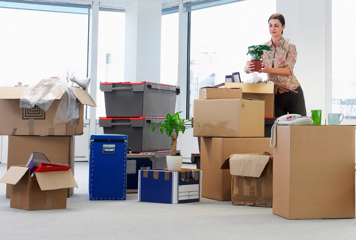 A Woman Sorting Out Boxes of Package