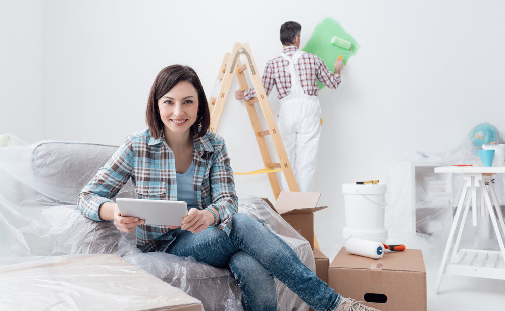 A Man Painting a Wall With Green Paint